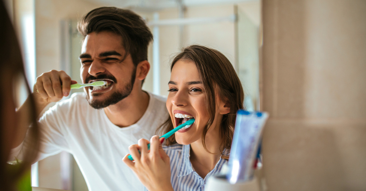 Couple brushing teeth